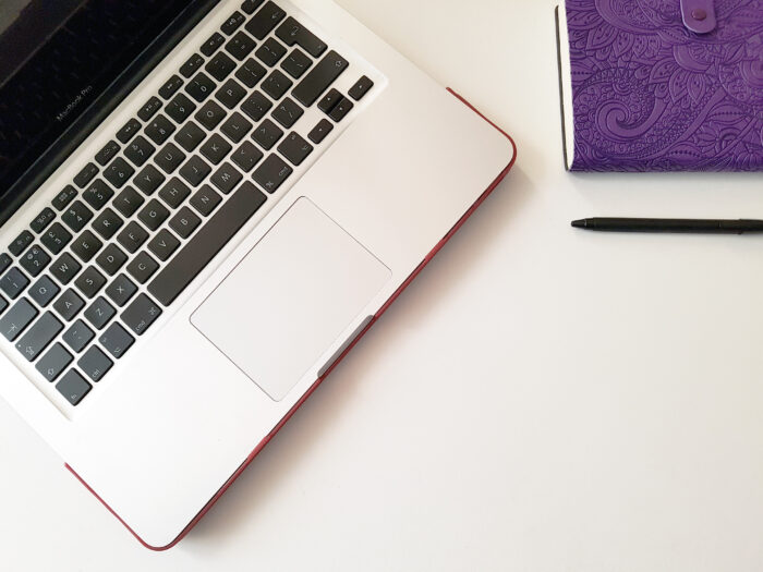 laptop with purple notebook
